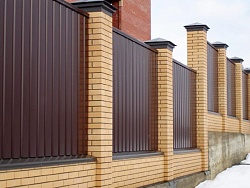 Забор из профнастила коричневый со столбами из красного кирпича